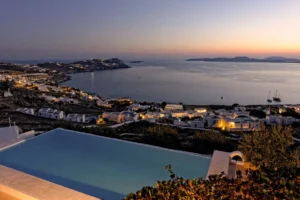 For Sale: Luxurious Villa with Stunning Aegean Views in Mykonos, Agios Ioannis Diakoftis Embodying the essence of "Location, Location, Location," this exquisite villa in Agios Ioannis Diakoftis, Mykonos, is the epitome of luxury and serenity. Set on a spacious 4,530 sq.m. plot with panoramic views of Delos and the Cyclades, this property offers breathtaking sunset vistas, an expansive infinity pool, and high-end amenities. Built in 2000, the villa seamlessly combines timeless elegance with modern conveniences, creating a tranquil retreat amid the allure of Mykonos. Property Details Location: Agios Ioannis Diakoftis, Mykonos Villa Size: 235 sq.m. Plot Size: 4,530 sq.m. Bedrooms: 4 Bathrooms: 4 Parking: Capacity for 5 cars Construction Year: 2000, with modern renovations Key Features This single-level villa welcomes you with an ambiance of warmth and luxury. Inside, the inviting living space is complemented by a cozy fireplace and underfloor heating, ideal for year-round comfort. High-quality finishes, thoughtful design, and spacious bedrooms ensure a sophisticated yet relaxing atmosphere. Interior Layout The villa comprises four elegantly designed bedrooms, each offering privacy and style. The two main suites, accessible via separate entrances, include a master suite with a double bed and a twin suite, both with en-suite bathrooms. The open-plan layout enhances the sense of spaciousness, and every room is designed to capture the striking views of the Aegean. Outdoor Space The landscaped grounds of this villa include lush gardens and an ancient olive tree, all framed by the endless horizon. The highlight is the large infinity pool, offering a seamless transition from the property to the blue sea. Comfortable sun loungers and outdoor seating provide ideal spaces for relaxation, while the vast plot allows for potential outdoor activities and social gatherings. Investment Potential The villa's prime location in Agios Ioannis and proximity to Mykonos town make it a highly attractive property, suitable as a primary residence or as a high-end vacation rental. The views of Delos and the surrounding Cyclades islands add unique appeal, making this villa a standout investment for those seeking a luxurious, secluded home in Greece's iconic island destination. For more information or to schedule a private viewing of this breathtaking villa, please reach out. This is an opportunity to own a piece of paradise in Mykonos, where the sky and sea become one.