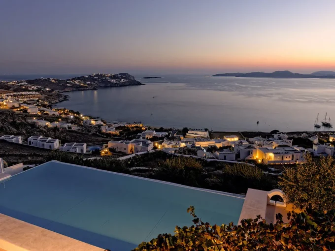 For Sale: Luxurious Villa with Stunning Aegean Views in Mykonos, Agios Ioannis Diakoftis Embodying the essence of "Location, Location, Location," this exquisite villa in Agios Ioannis Diakoftis, Mykonos, is the epitome of luxury and serenity. Set on a spacious 4,530 sq.m. plot with panoramic views of Delos and the Cyclades, this property offers breathtaking sunset vistas, an expansive infinity pool, and high-end amenities. Built in 2000, the villa seamlessly combines timeless elegance with modern conveniences, creating a tranquil retreat amid the allure of Mykonos. Property Details Location: Agios Ioannis Diakoftis, Mykonos Villa Size: 235 sq.m. Plot Size: 4,530 sq.m. Bedrooms: 4 Bathrooms: 4 Parking: Capacity for 5 cars Construction Year: 2000, with modern renovations Key Features This single-level villa welcomes you with an ambiance of warmth and luxury. Inside, the inviting living space is complemented by a cozy fireplace and underfloor heating, ideal for year-round comfort. High-quality finishes, thoughtful design, and spacious bedrooms ensure a sophisticated yet relaxing atmosphere. Interior Layout The villa comprises four elegantly designed bedrooms, each offering privacy and style. The two main suites, accessible via separate entrances, include a master suite with a double bed and a twin suite, both with en-suite bathrooms. The open-plan layout enhances the sense of spaciousness, and every room is designed to capture the striking views of the Aegean. Outdoor Space The landscaped grounds of this villa include lush gardens and an ancient olive tree, all framed by the endless horizon. The highlight is the large infinity pool, offering a seamless transition from the property to the blue sea. Comfortable sun loungers and outdoor seating provide ideal spaces for relaxation, while the vast plot allows for potential outdoor activities and social gatherings. Investment Potential The villa's prime location in Agios Ioannis and proximity to Mykonos town make it a highly attractive property, suitable as a primary residence or as a high-end vacation rental. The views of Delos and the surrounding Cyclades islands add unique appeal, making this villa a standout investment for those seeking a luxurious, secluded home in Greece's iconic island destination. For more information or to schedule a private viewing of this breathtaking villa, please reach out. This is an opportunity to own a piece of paradise in Mykonos, where the sky and sea become one.